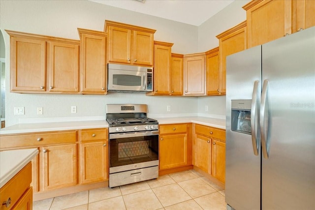 kitchen with light tile patterned flooring and appliances with stainless steel finishes