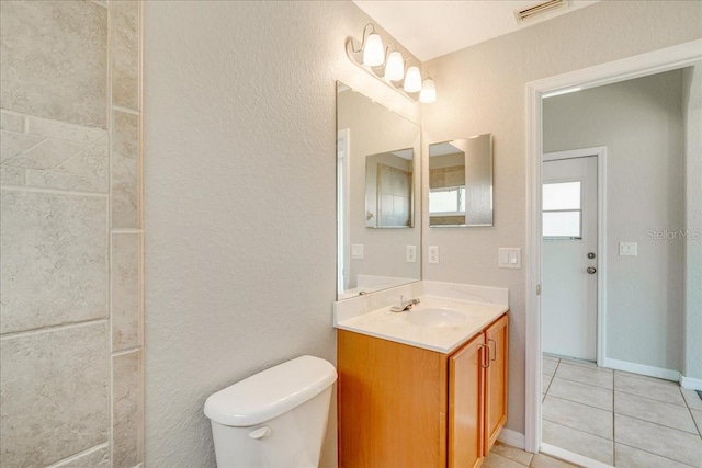 bathroom featuring tile patterned floors, vanity, and toilet