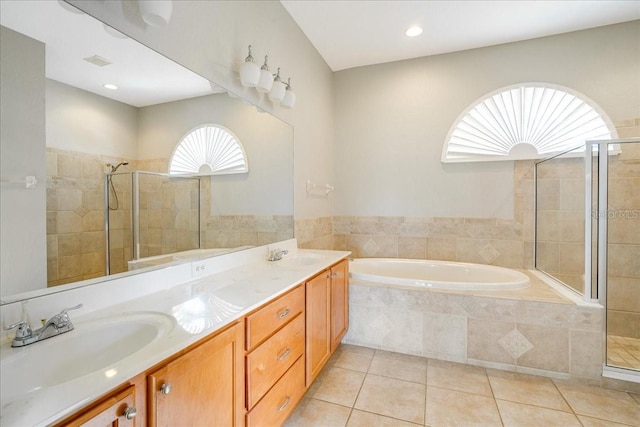 bathroom with tile patterned flooring, vanity, and independent shower and bath