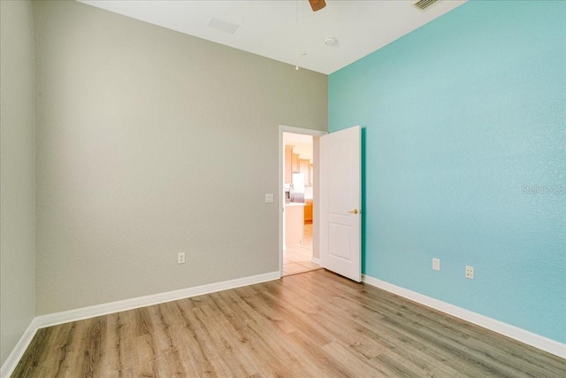 unfurnished room with ceiling fan and light hardwood / wood-style flooring