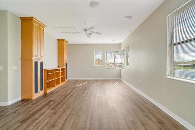 unfurnished living room with hardwood / wood-style flooring and ceiling fan