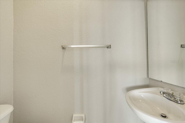 bathroom with toilet and sink