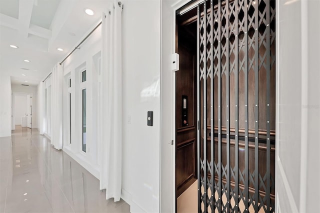 corridor featuring light tile patterned floors and elevator