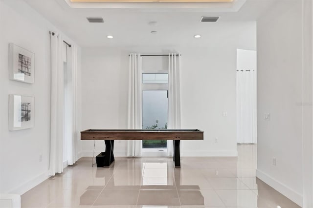 hallway with light tile patterned floors