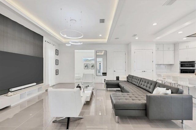 tiled living room with a tray ceiling