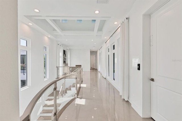 corridor with beamed ceiling, light tile patterned floors, and coffered ceiling