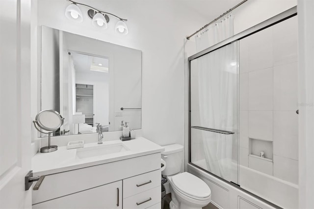 full bathroom featuring vanity, enclosed tub / shower combo, and toilet