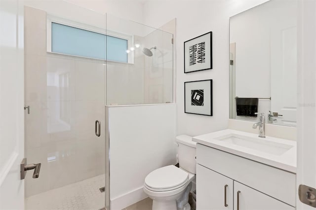 bathroom with vanity, toilet, and walk in shower