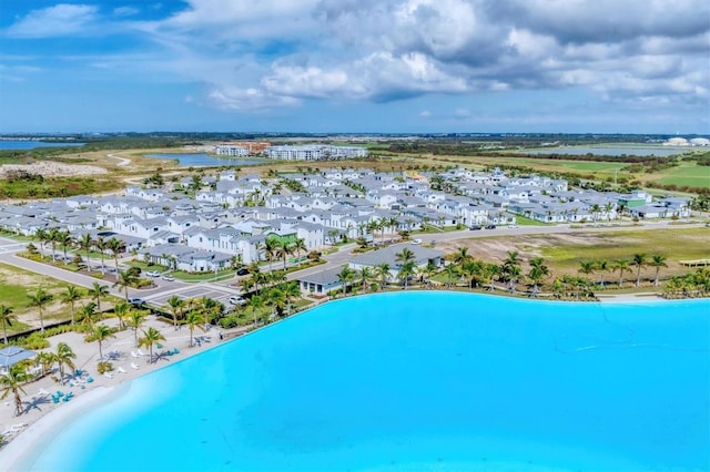 birds eye view of property featuring a water view and a view of the beach