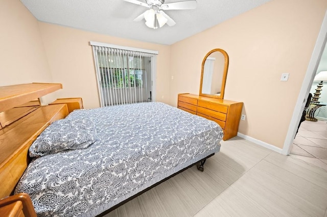 bedroom with ceiling fan, a textured ceiling, and access to outside