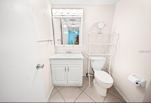 bathroom with tile patterned flooring, vanity, and toilet