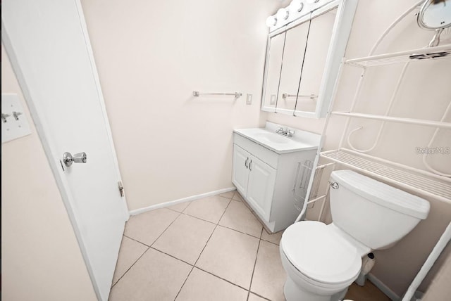 bathroom featuring tile patterned flooring, vanity, and toilet