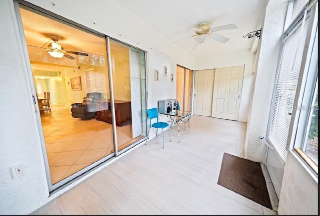 sunroom / solarium with ceiling fan