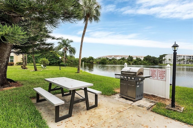 surrounding community featuring a lawn and a water view