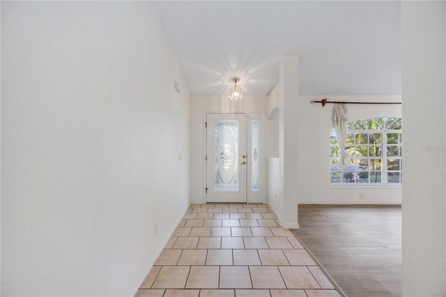 entrance foyer with an inviting chandelier and light tile patterned floors