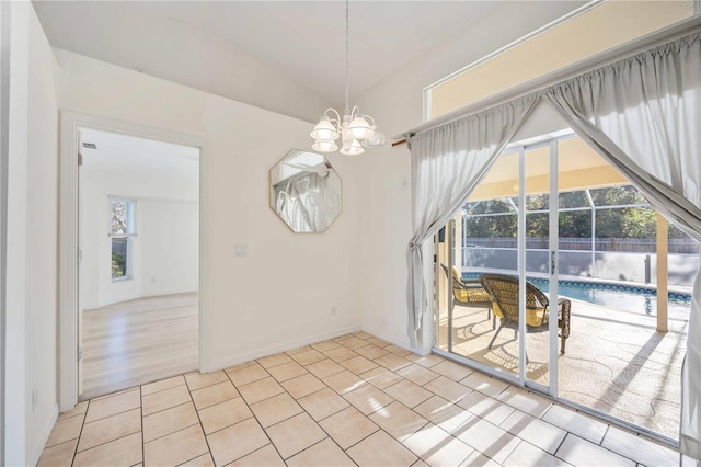 dining space featuring an inviting chandelier and light tile patterned floors