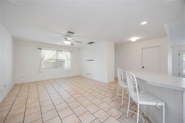 interior space with ceiling fan