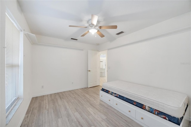 unfurnished bedroom with ceiling fan and light wood-type flooring