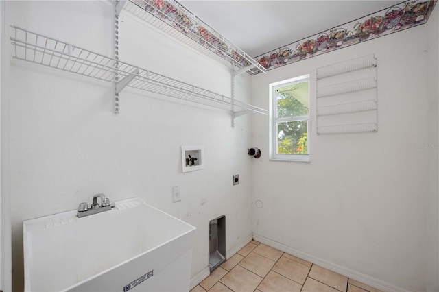 laundry room featuring electric dryer hookup, sink, light tile patterned floors, and washer hookup