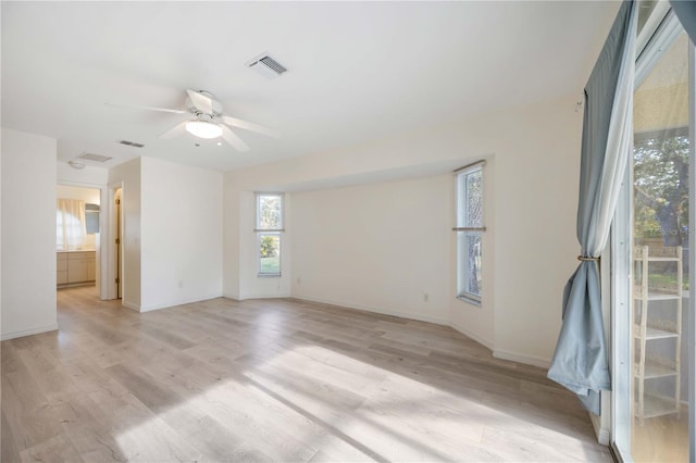 spare room featuring ceiling fan and light wood-type flooring