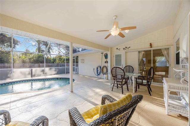 view of pool with a patio area, ceiling fan, and glass enclosure