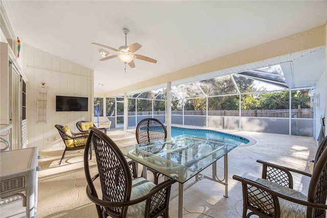 view of pool featuring ceiling fan, a patio, and glass enclosure