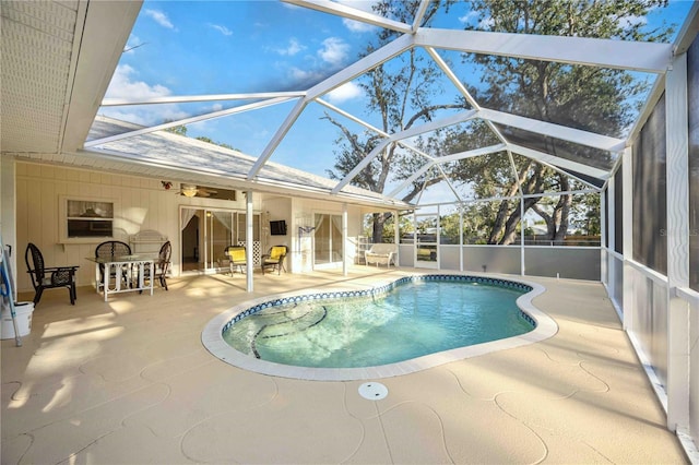 view of swimming pool with a patio area and glass enclosure