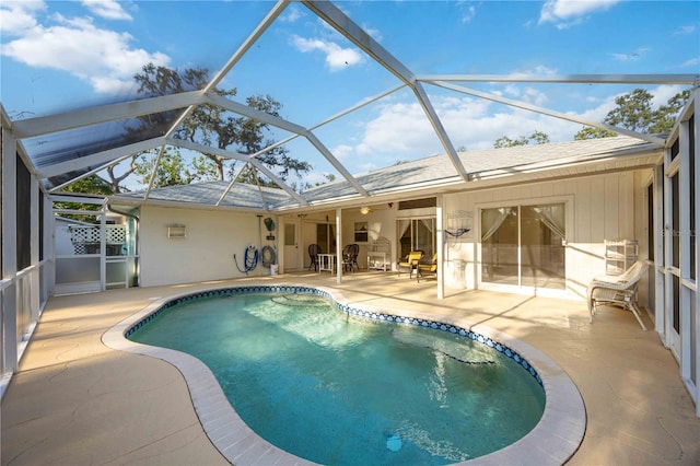 view of pool with a patio and glass enclosure