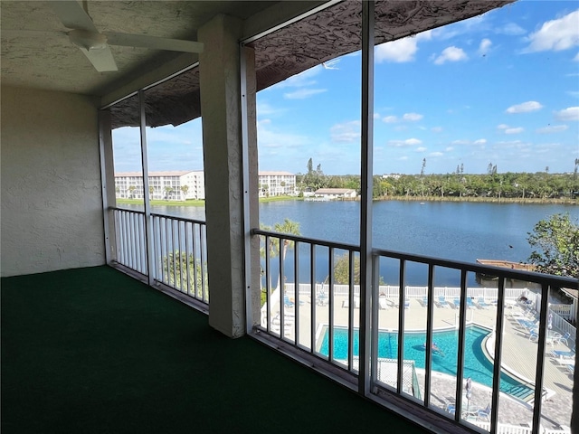 unfurnished sunroom with a water view