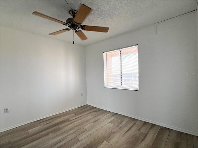 unfurnished room with ceiling fan, a textured ceiling, and light hardwood / wood-style flooring