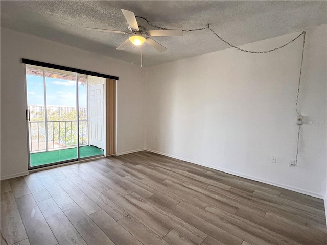 empty room with ceiling fan, a textured ceiling, and light hardwood / wood-style floors