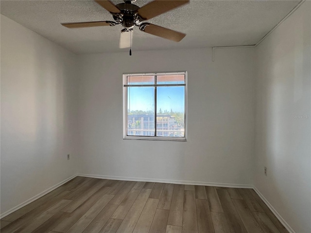 unfurnished room with hardwood / wood-style floors, a textured ceiling, and ceiling fan