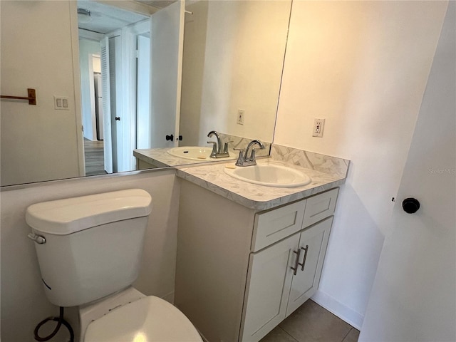 bathroom featuring tile patterned flooring, vanity, and toilet