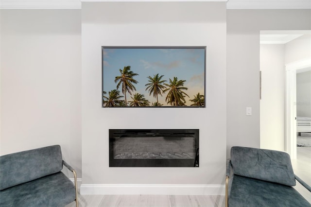 living area featuring crown molding