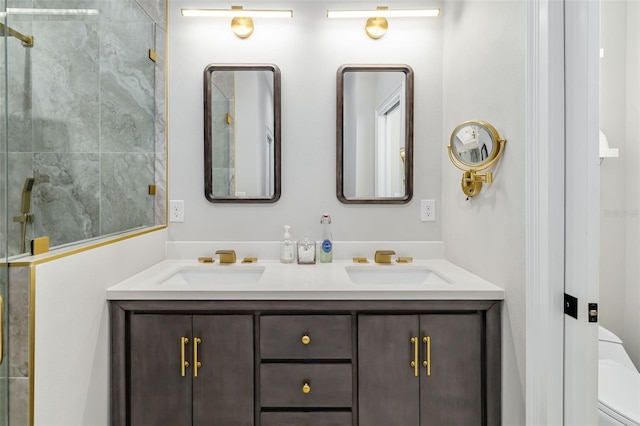 bathroom with vanity, toilet, and a shower with door