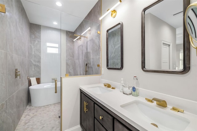 bathroom featuring vanity, tile patterned floors, tile walls, and independent shower and bath