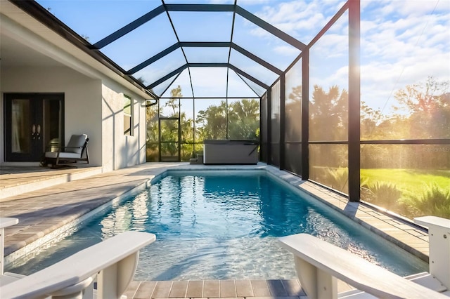 view of pool with a patio area and glass enclosure