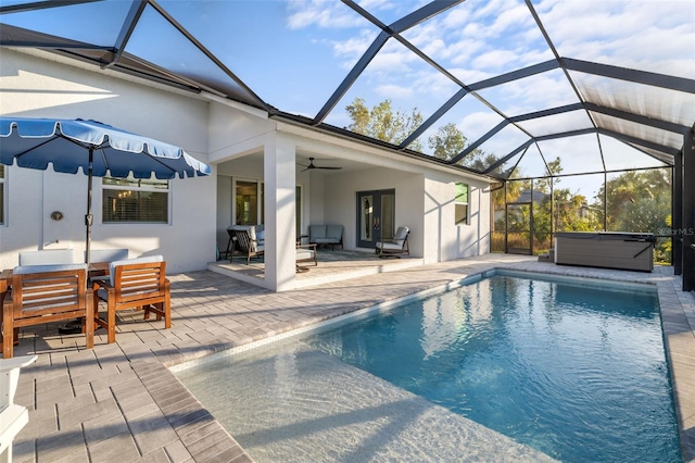 view of pool featuring a lanai, ceiling fan, and a patio area