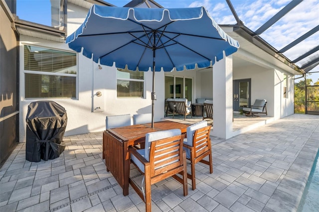 view of patio featuring glass enclosure