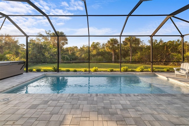 view of swimming pool featuring a lanai and a patio