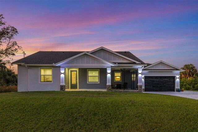 craftsman inspired home with a porch, a garage, and a lawn