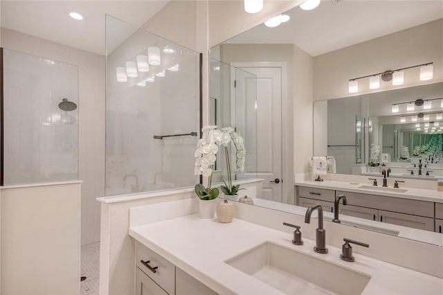 bathroom with vanity and tiled shower