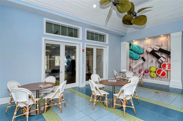 sunroom with ceiling fan and french doors