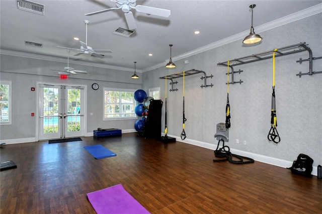 gym with ceiling fan, dark wood-type flooring, and ornamental molding