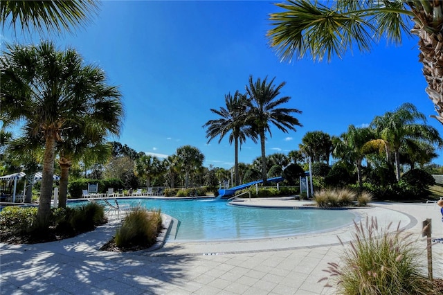 view of swimming pool with a water slide