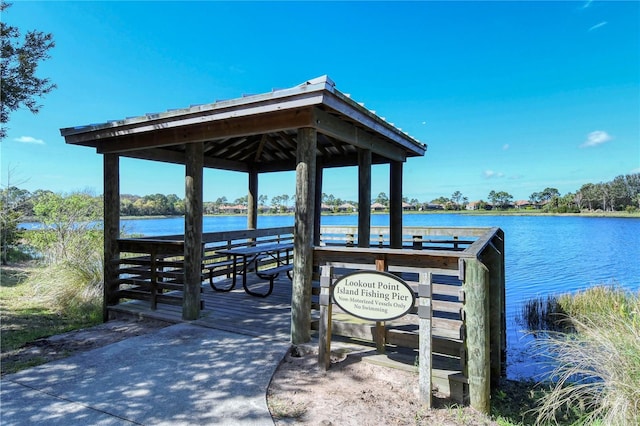 dock area featuring a gazebo, a water view, and exterior bar