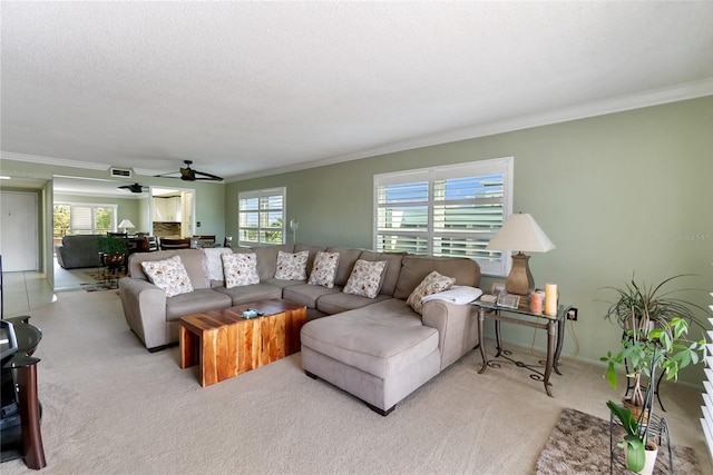 living room with light carpet, plenty of natural light, and ceiling fan