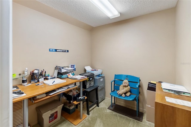 carpeted office space featuring a textured ceiling