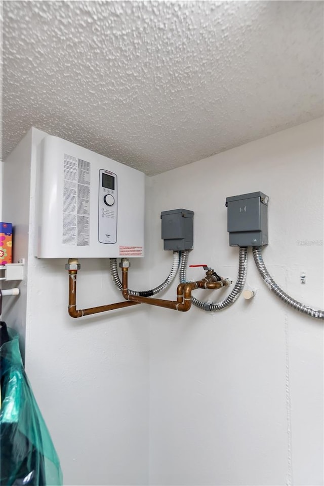 details featuring a textured ceiling and tankless water heater