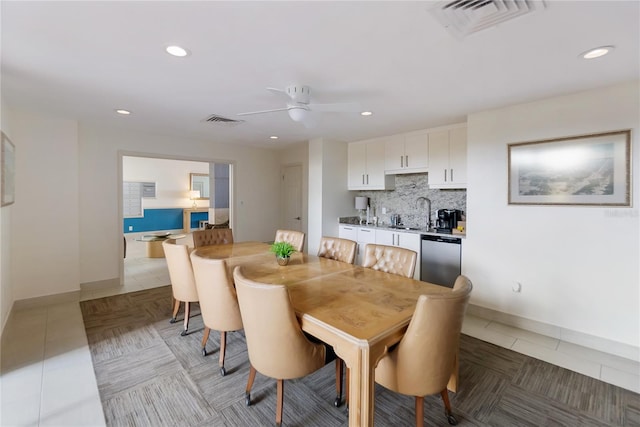 dining space featuring ceiling fan, light tile patterned flooring, and sink